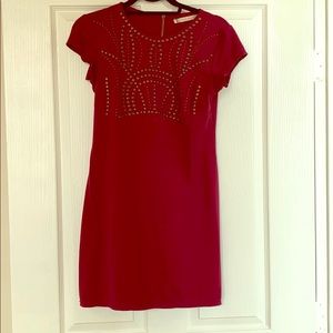 Burgundy dress with brass accents